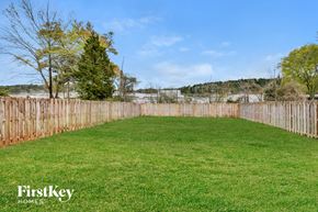 Irondale house for rent - a fenced in backyard with green grass and a fence