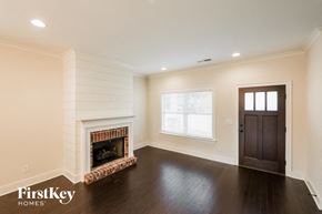 Birmingham house for rent - a living room with a fireplace and a dark wood floor