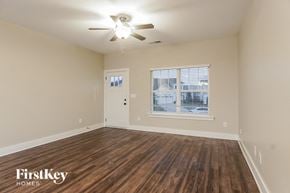 Birmingham house for rent - an empty living room with a ceiling fan and a window