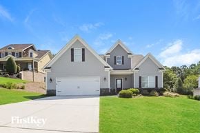 Gainesville house for rent - a house with a green lawn and a white driveway