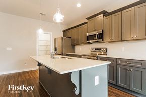 Cullman house for rent - a kitchen with gray cabinets and a white counter top