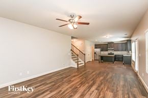 Hoschton house for rent - an open living room with a kitchen and a ceiling fan