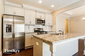 Trussville house for rent - a kitchen with stainless steel appliances and a granite counter top