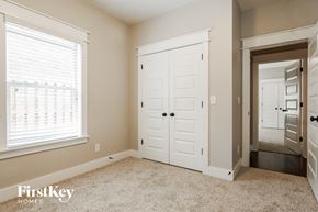 Trussville house for rent - a bedroom with a closet and a white door and a window