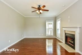 Clarksville house for rent - A room with a fireplace and a ceiling fan.