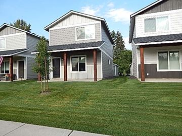Rathdrum house for rent - a green lawn in front of some houses