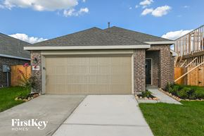 Hockley house for rent - A house with a garage door and a FirstKey Homes logo.