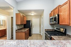 Mesa house for rent - a kitchen with wooden cabinets and a stove and a microwave