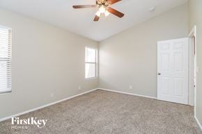 Mesa house for rent - a bedroom with carpet and a ceiling fan