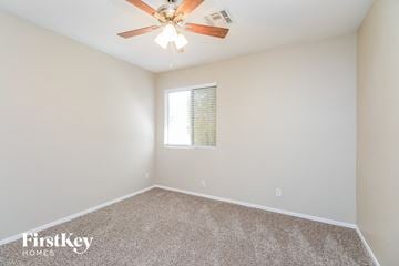 Mesa house for rent - the spacious living room with ceiling fan and carpet