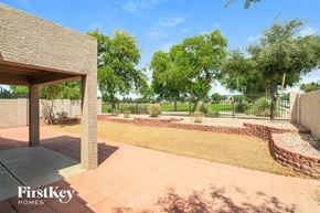 Mesa house for rent - a view of the backyard of a house with a garden and trees