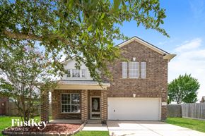 Pearland house for rent - front view of a brick house with a white garage door