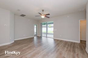 Lakeland house for rent - A spacious room with a ceiling fan and sliding glass doors.