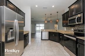Lakeland house for rent - A kitchen with a refrigerator that says FirstKey Homes.