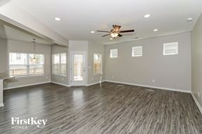Acworth house for rent - A spacious room with wood flooring and a ceiling fan.
