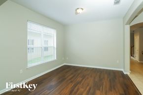 Jacksonville house for rent - the spacious living room with hardwood flooring and a large window