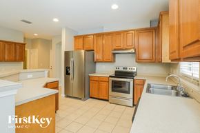 Jacksonville house for rent - a kitchen with wooden cabinets and stainless steel appliances