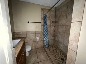 Bay City house for rent - A bathroom with a toilet, sink, and shower.