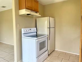 Bay City house for rent - an empty kitchen with a stove and refrigerator