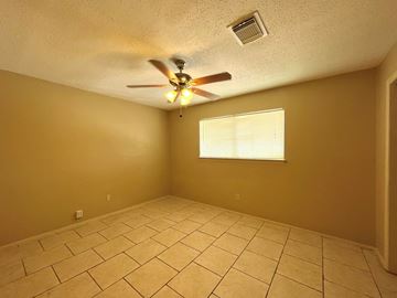 Bay City house for rent - the living room has a ceiling fan and a tiled floor