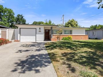Stockton house for rent - a white house with a driveway and a garage door