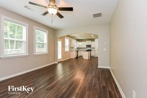 Canton house for rent - an empty living room and kitchen with a ceiling fan