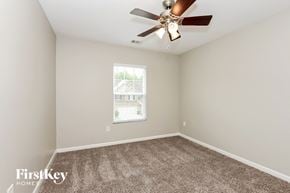 Canton house for rent - an empty bedroom with a ceiling fan and a window