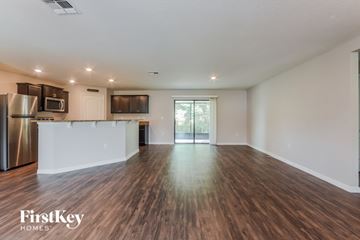 Deltona house for rent - A spacious kitchen with wooden floors and a white countertop.