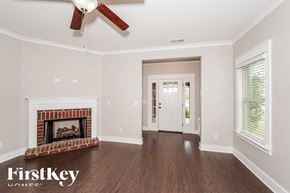Gardendale house for rent - a living room with a fireplace and a ceiling fan