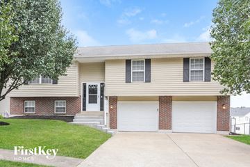 Wentzville house for rent - a beige house with a white garage door