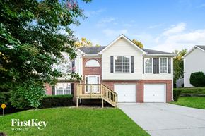 Suwanee house for rent - A house with a garage and a porch is shown in the image.