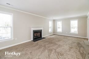 High Point house for rent - the living room has a fireplace and carpeted flooring