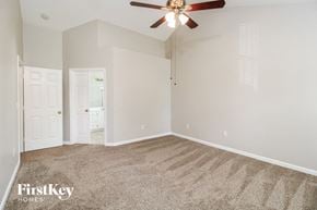High Point house for rent - a bedroom with carpet and a ceiling fan
