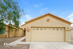 Tucson house for rent - a tan house with a white garage door