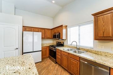 Tucson house for rent - an updated kitchen with granite counter tops and wooden cabinets