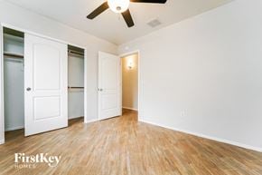 Tucson house for rent - a bedroom with a closet and a ceiling fan
