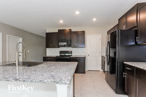 Riverview house for rent - A kitchen with granite countertops and black appliances.