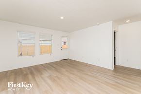 Converse house for rent - A room with wooden flooring and a door on the right side.