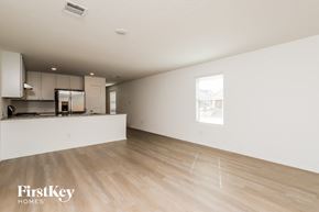 Converse house for rent - A spacious empty room with wooden flooring and white walls.