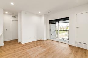 Troy apartment for rent - a living room with white walls and a sliding glass door to a balcony