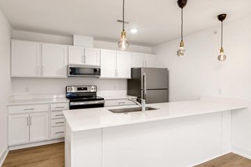 Troy apartment for rent - a white kitchen with stainless steel appliances and white counter tops
