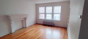 Chicago apartment for rent - a living room with a fireplace and a window
