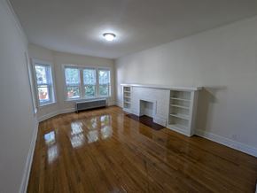 Chicago apartment for rent - A room with a fireplace and wooden floors.