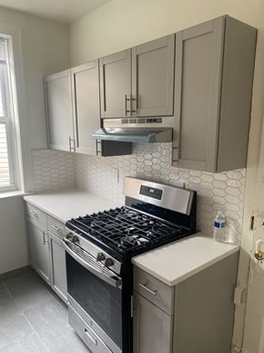 Chicago apartment for rent - A kitchen with a black stove top oven and a white counter top.