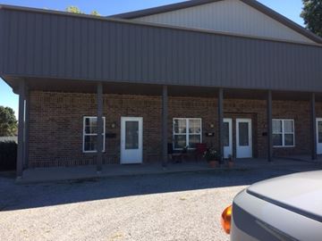 Clinton apartment for rent - the front of a brick building with a porch