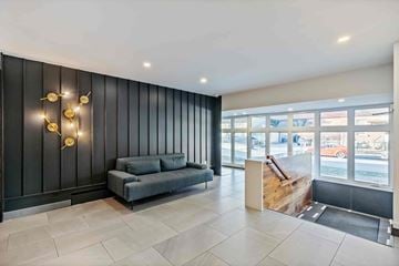Ottawa apartment for rent - A modern living room with a grey sofa and a wooden coffee table.