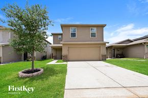 Houston house for rent - A house with a tree in front of it and the words "FirstKey Homes" on the bottom left.