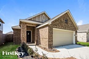 New Caney house for rent - A brick house with a garage door is for sale.