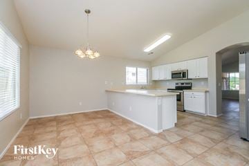 Queen Creek house for rent - an open kitchen and living room with a sink and a counter top