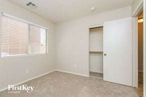Queen Creek house for rent - an empty bedroom with a closet and a window